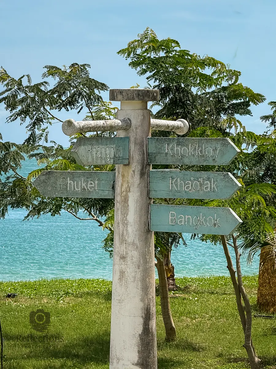 Phuket to Bangkok scenic coastal drive—direction sign at Sarasin Bridge pointing to Phuket, Phang Nga, Khaolak, and Bangkok.