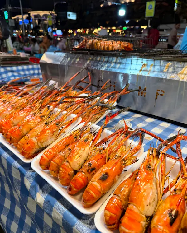 Fresh seafood displayed at outdoor food stalls at Banzaan Market in Patong Phuket at night