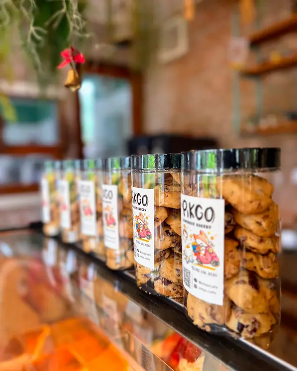 Cookie jars lined up inside a café during a slow travel experience in Thailand
